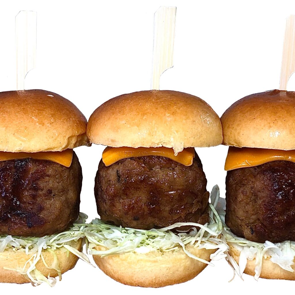 Thick beef sliders with juicy Japanese-style Hamburg patties, cheddar cheese, fresh shredded cabbage, and soft brioche buns, secured with bamboo skewers.