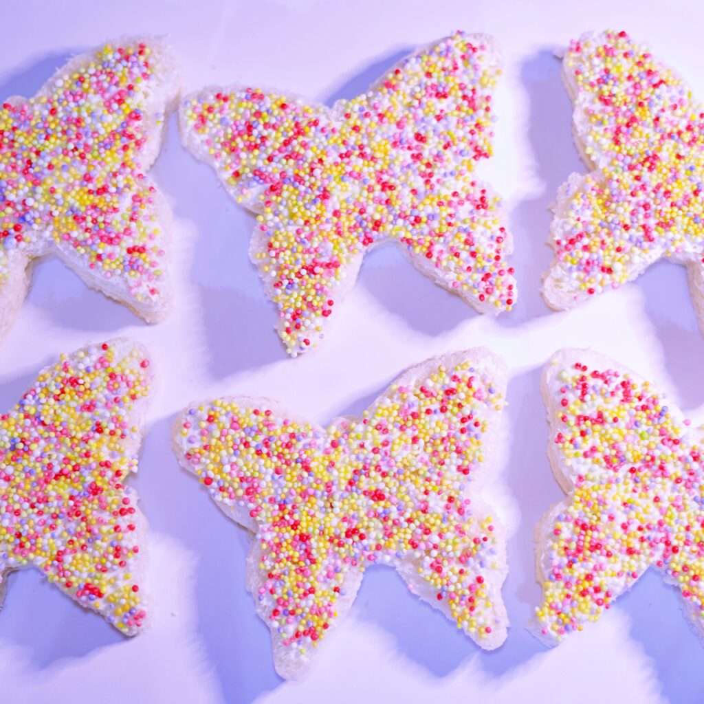 Butterfly-shaped cream cheese sandwich for kids party catering, decorated with fresh vegetables and colorful presentation.